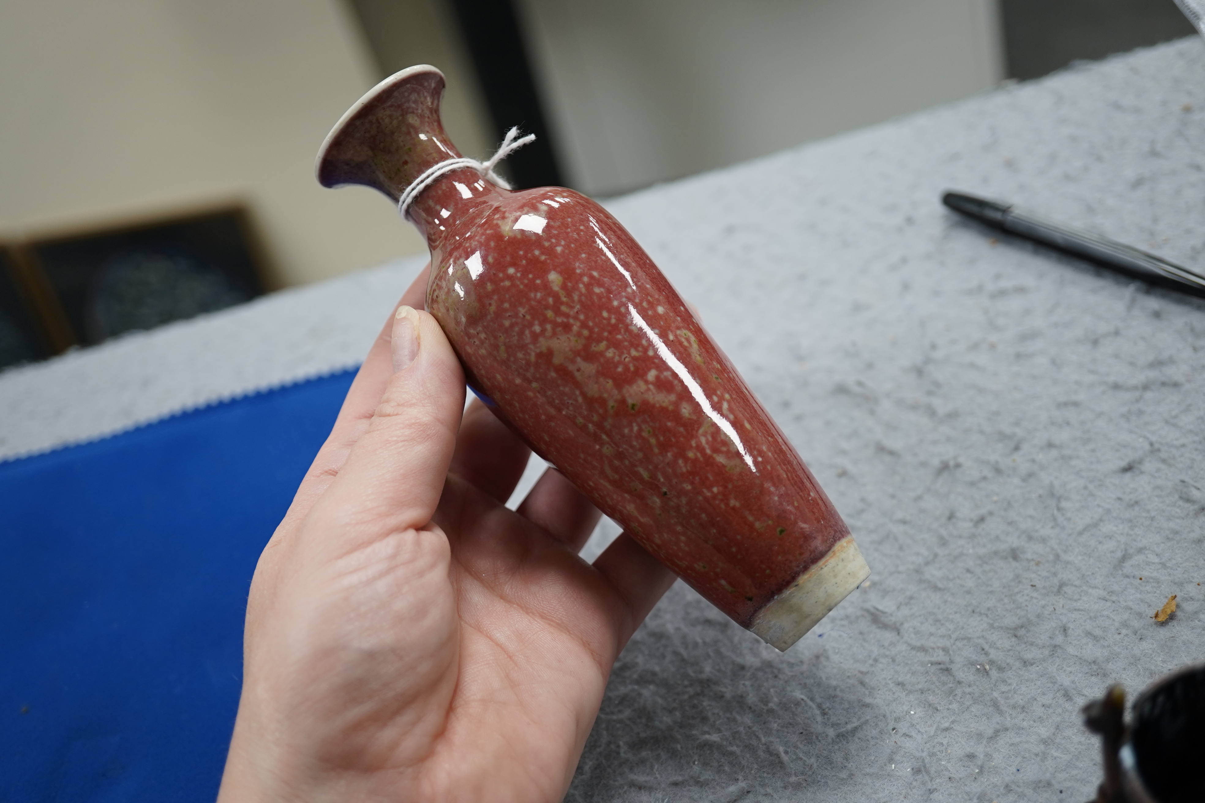 A small Chinese peach bloom glazed vase with fitted wood stand, Republic period